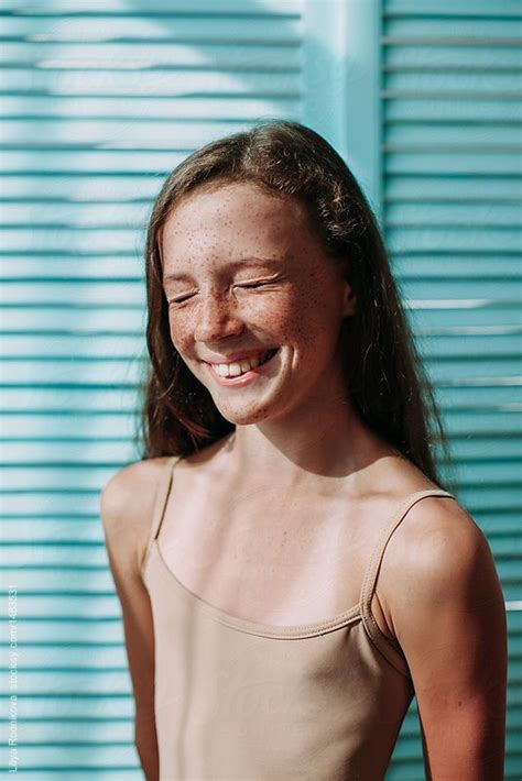 Girl Laughing With Closed Eyes With Freckles And Bright Personality By