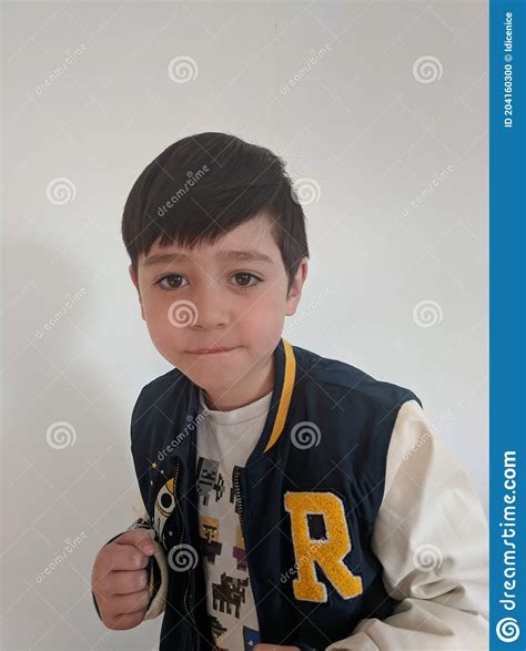 A Little Boy In A Blue And White Jacket With Fighting Posture Stock