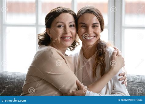 Portrait Of Smiling Middle Aged Mom And Adult Daughter Stock Photo Image Of Laughter Camera