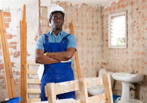 Confident African American Construction Worker In House Under