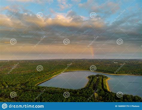 Rainbow In The Nice Sunset Scene Over A Lake With Forest Sky Stock