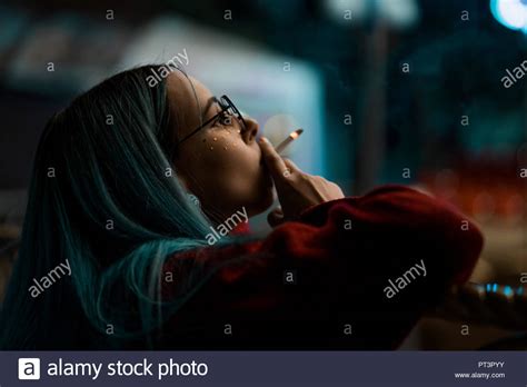 Millennial Cool Pretty Girl With Unusual Dyed Hairstyle Smoking