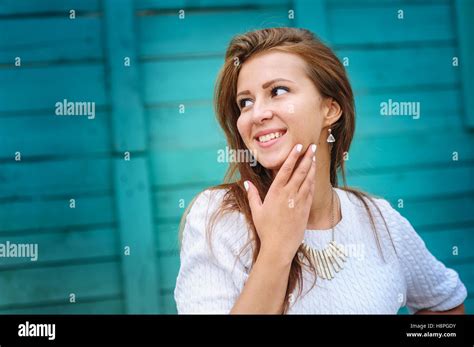 Smiling Young Woman Posing Against Wooden Fence Stock Photo Alamy