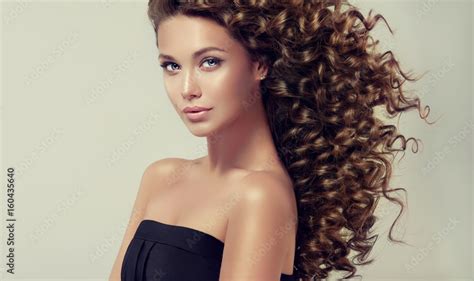 Brunette Girl With Long And Shiny Curly Hair Beautiful Model With Wavy Hairstyle Photos