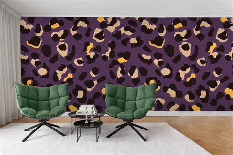 Two Green Chairs Sitting In Front Of A Purple Wall With Leopard Print