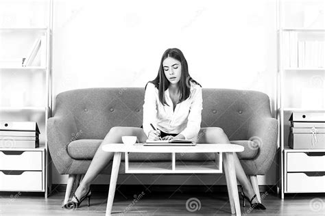 seductive secretary with legs sit on sofa in office businesswoman sensual girl employee stock