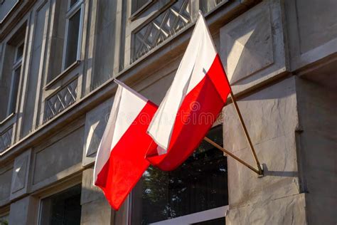 Two Polish National Flags On A Building In A Slight Wind Stock Photo