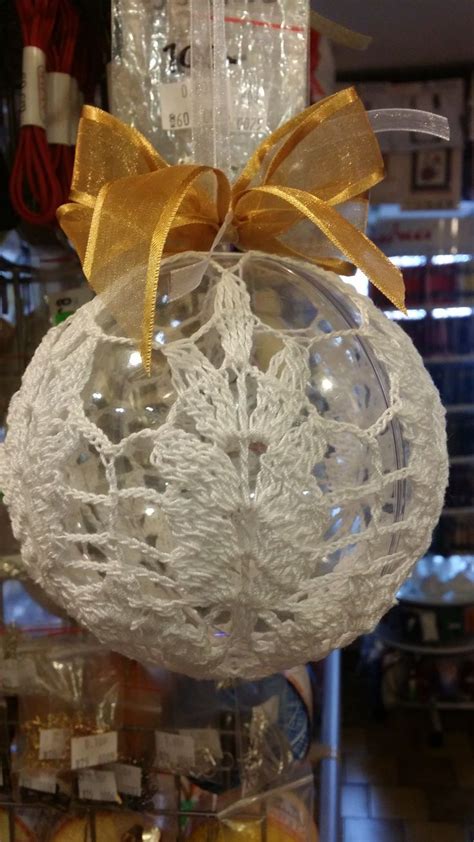 A Glass Ornament With A Yellow Bow Hanging From It S Side In A Store