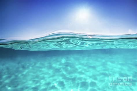 Half Underwater Shot Clear Water And Sunny Blue Sky Tropical Ocean