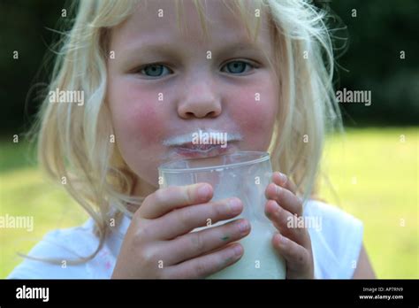 Smiling Young Girl Drinking Milk Stock Photo Alamy