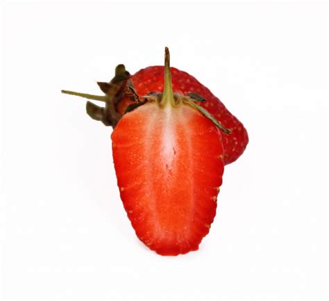 One Sliced Strawberry And One Strawberry On White Background