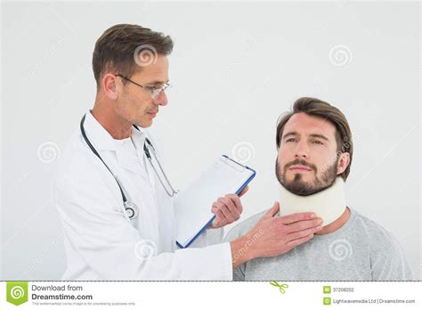 Male Doctor Examining A Patients Sprained Neck Stock Photo Image Of