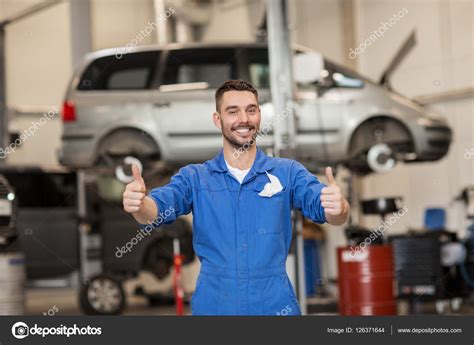 Happy Auto Mechanic Man Or Smith At Car Workshop Stock Photo By ©syda