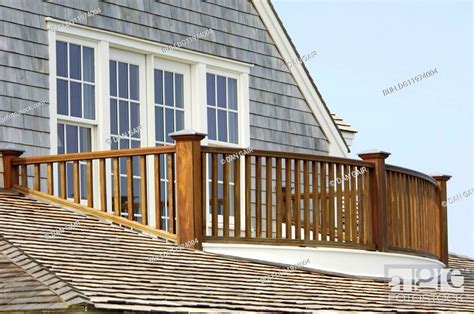 Wooden Balcony Railing And Shingled Roof Stock Photo Picture And