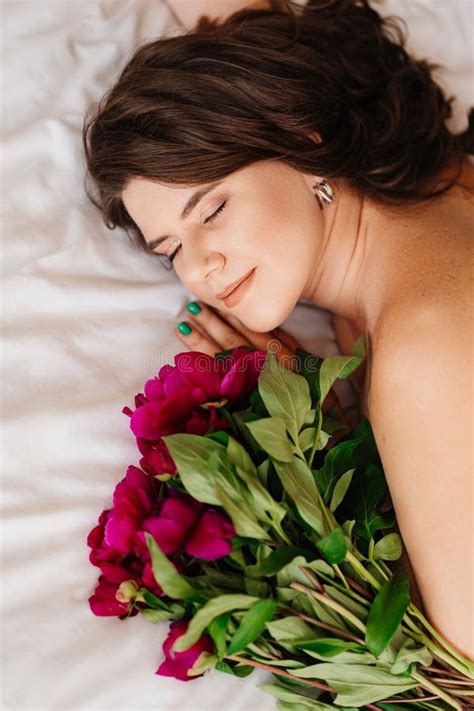 Gentle Brunette Topless Woman With A Bouquet Of Peonies On The Bed Stock Image Image Of