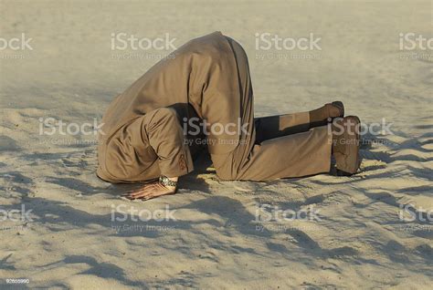 Businessman With Head Stuck In Sand At The Beach Stock Photo Download