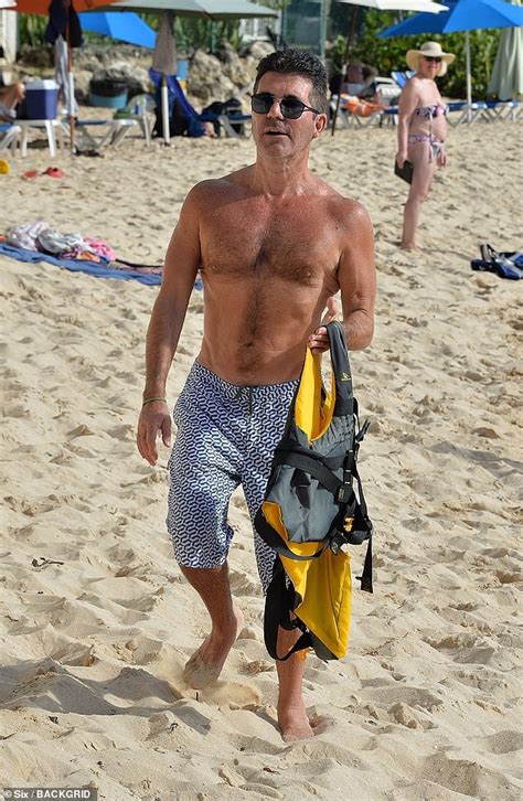 shirtless simon cowell enjoys barbados beach with son eric daily mail online