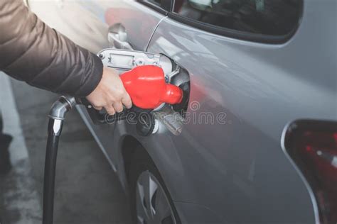 Closeup Of Man Pumping Gasoline Fuel In Car At Gas Station Stock Image