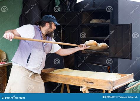 Baker Puts Bread On The Shovel Into The Oven Stock Image Image Of