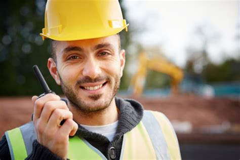 Happy Construction Worker On Walkie Talkie Stock Photo Download Image