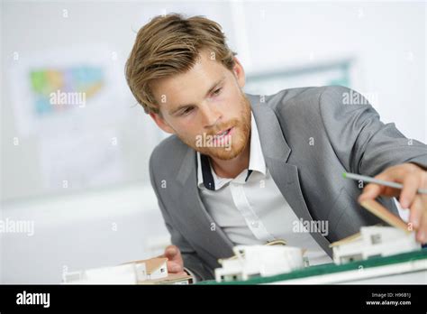Handsome Architect Working On House Models Stock Photo Alamy