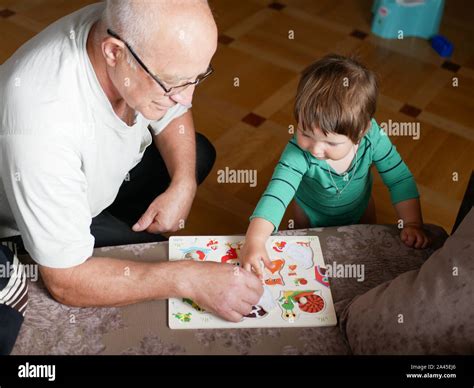 A Boy Is Playing With Grandfather Grandfather And Grandson Are Having