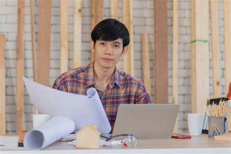 Young Handsome Asian Male Architect With Black Hair Wearing Plaid Shirt