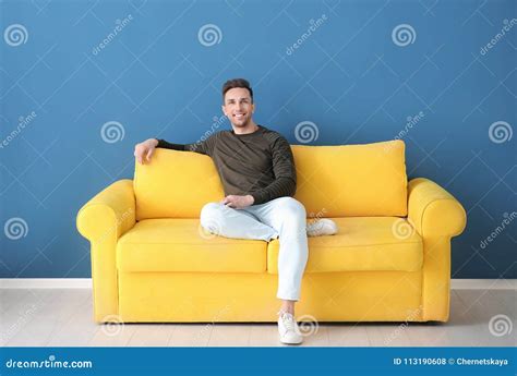 Handsome Young Man Sitting On Sofa Stock Photo Image Of Comfortable