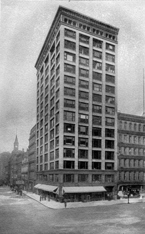 An Old Black And White Photo Of A Large Building In The Middle Of A City