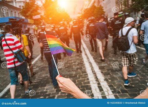 hand hold a gay lgbt flag at lgbt gay pride parade festival editorial photography image of