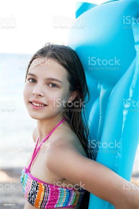 Cheerful Girl Walking Near The Sea With Blue Raft Stock Photo IStock