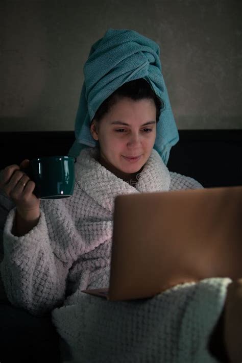 Woman Laying Down In Bed With Wet Head Covered With Towel Working On Laptop Stock Image Image