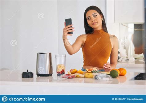 Living That Healthy Life A Woman Taking A Selfie While Making A Smoothie At Home Stock Image