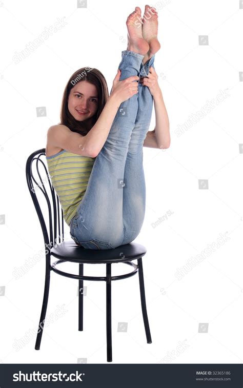 Girl In Green Stripy Top Sit On Stool Take Legs Up Isolated On White