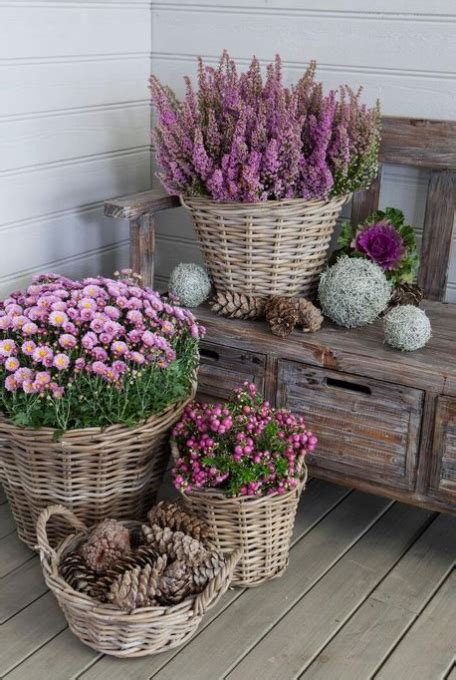Three Baskets Filled With Flowers Sitting On Top Of A Wooden Floor Next