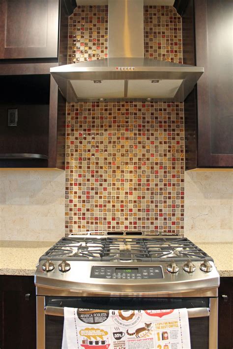 17 of our favorite tile backsplash ideas for behind the stove in the kitchen. #Kitchen mosaic tile backsplash with stainless steel vent ...