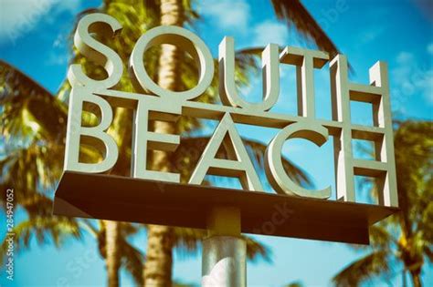 Scenic Sunlit View Of The Entrance To South Beach Sign With A Tropical