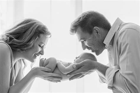 Parents Holding Their Newborn In Their Hands by Lea Csontos