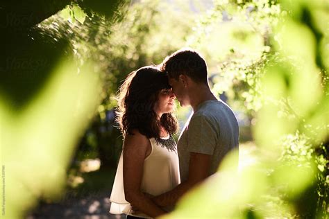 Hugging Couple In Sunny Park By Stocksy Contributor Guille Faingold Stocksy