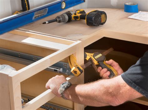 Cabinets are the main focal point of any kitchen, but they also affect many other project components—like electrical, plumbing, flooring, drywall, countertops, painting, and most importantly, the tradesmen who perform these tasks. Construction Worker Installing Kitchen Cabinets Stock ...