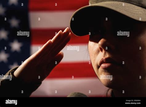 Memorial Day A Female Soldier In Uniform Salutes Against The