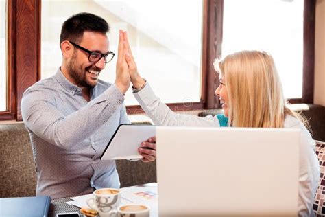 Happy Young Male And Female Business People Giving Each Other A High