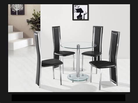 clear glass chrome dining table   black chairs