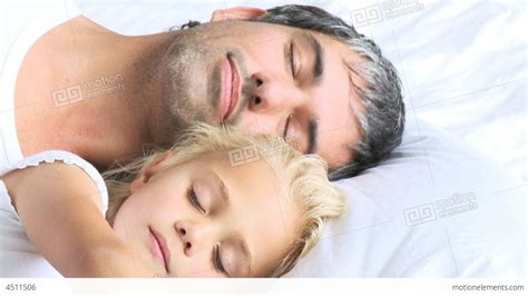 Smiling Father And Daughter Lying On Bed In Bedroom Stock Photo Image