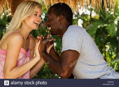Young Interracial Couple On Vacation In A Playful Mood