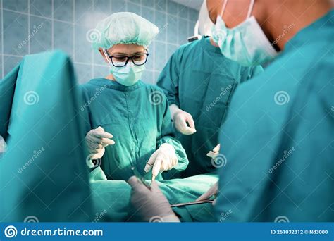 Group Of Surgeon At Work In Operating Room In Hospital Stock Photo