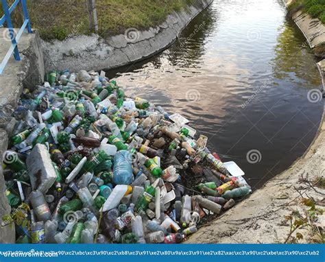 Water Pollution Plastic Bottles And Garbage On River Surface Editorial