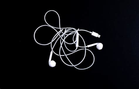 Premium Photo White Headphones Close Up On A Black Background