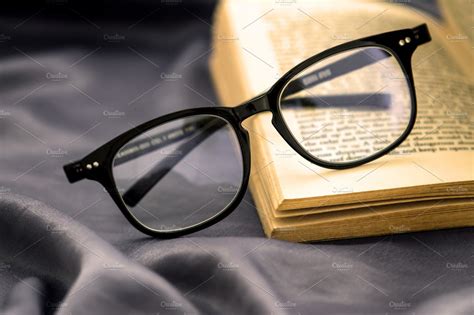 Reading Eyeglasses With Opened Book Containing Aged Background And Book School And Education