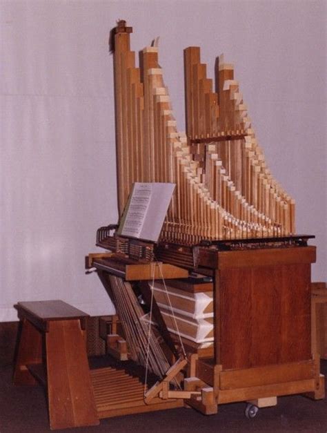 The Organ Is Made Out Of Wood And Has Musical Instruments On It